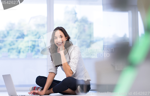 Image of young women using laptop computer on the floor