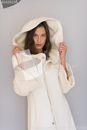 Image of woman in a white coat with hood isolated on white background