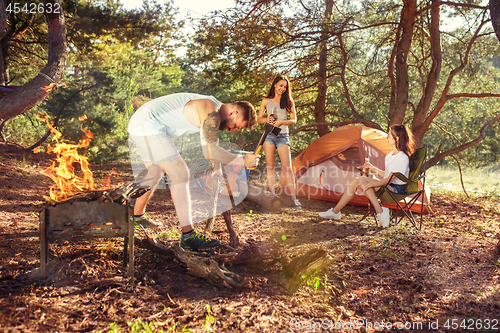 Image of Party, camping of men and women group at forest. They relaxing