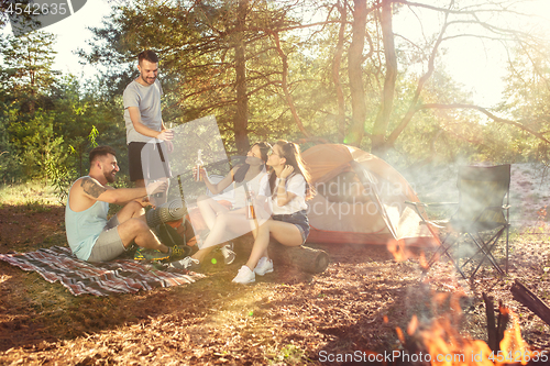 Image of Party, camping of men and women group at forest. They relaxing