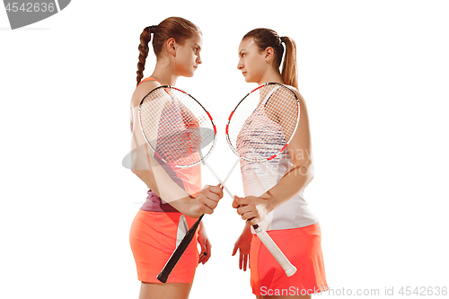 Image of Young women badminton players posing over white background