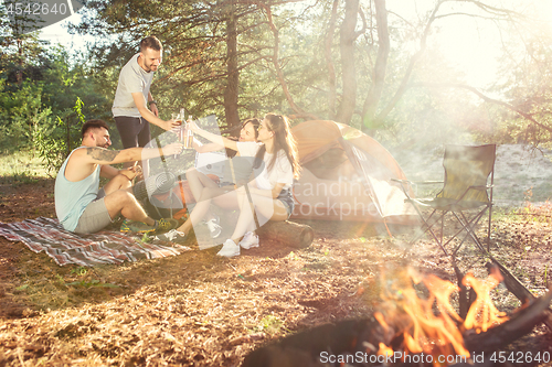 Image of Party, camping of men and women group at forest. They relaxing