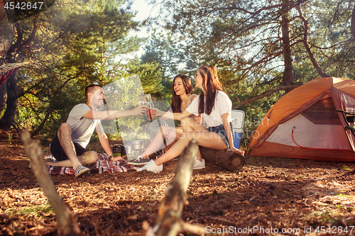 Image of Party, camping of men and women group at forest. They relaxing