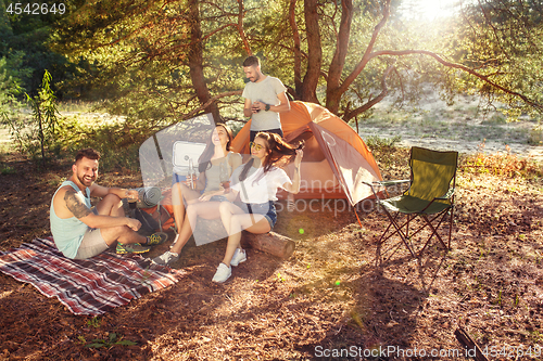 Image of Party, camping of men and women group at forest. They relaxing