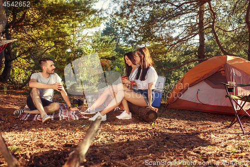 Image of Party, camping of men and women group at forest. They relaxing