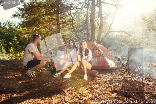 Image of Party, camping of men and women group at forest. They relaxing