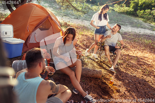 Image of Party, camping of men and women group at forest. They relaxing