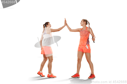 Image of Young women badminton players as winners posing over white background