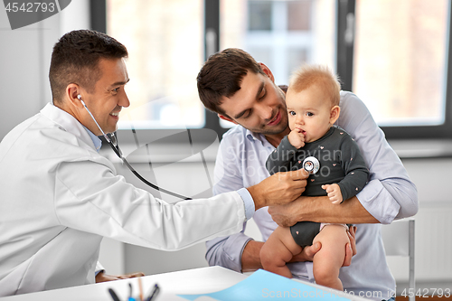 Image of father with baby and doctor at clinic