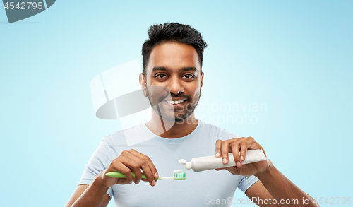 Image of indian man with toothbrush and toothpaste