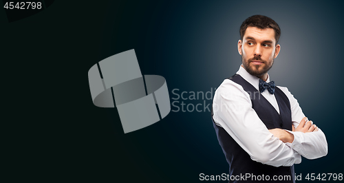 Image of man in shirt and bowtie over black background