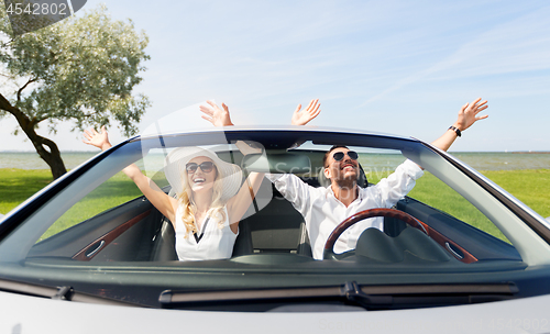 Image of happy man and woman driving in cabriolet car