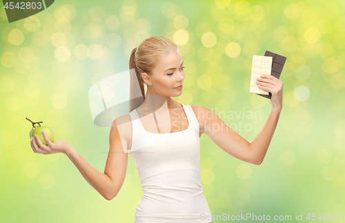 Image of woman choosing between green apple chocolate