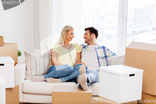 Image of happy couple with boxes moving to new home