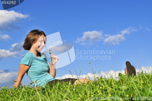 Image of Young girl sitting on grass