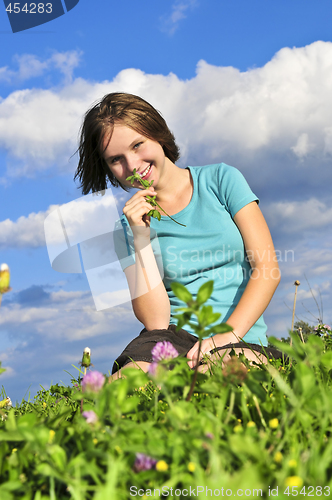 Image of Young girl sitting on grass