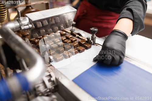 Image of candies making by chocolate coating machine