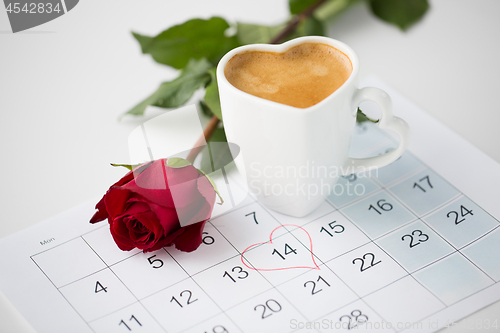 Image of close up of calendar, heart, coffee and red rose