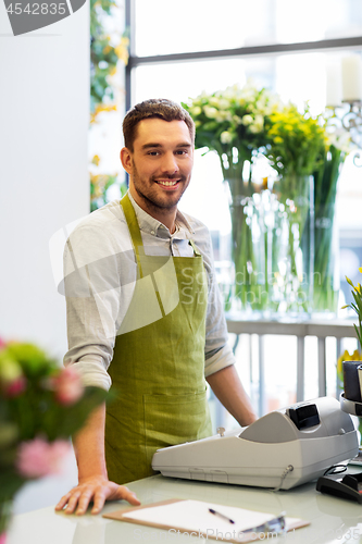 Image of florist man or seller at flower shop counter