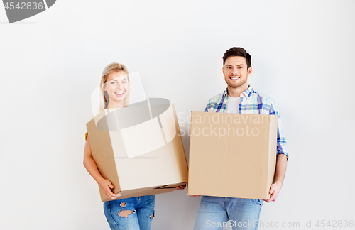 Image of happy couple with boxes moving to new home