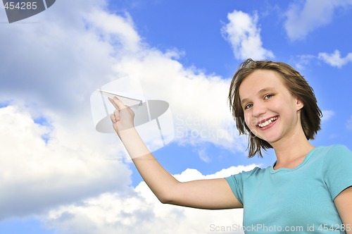 Image of Young girl holding paper airplane