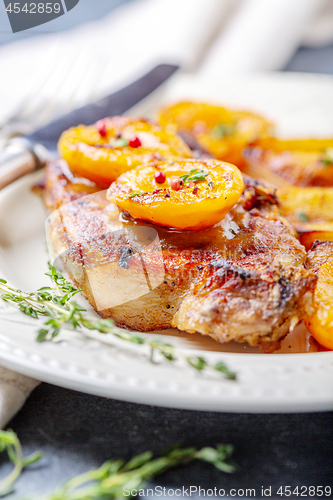 Image of Juicy pork steak with apricots,thyme and potatoes.