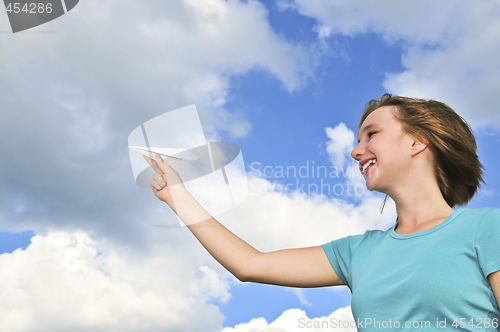 Image of Young girl holding paper airplane