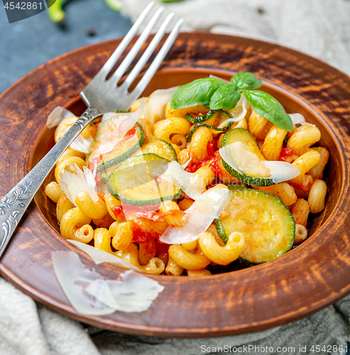 Image of Pasta with tomato and zucchini sauce close-up.