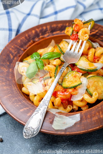 Image of Italian pasta cavatappi with zucchini and tomatoes.