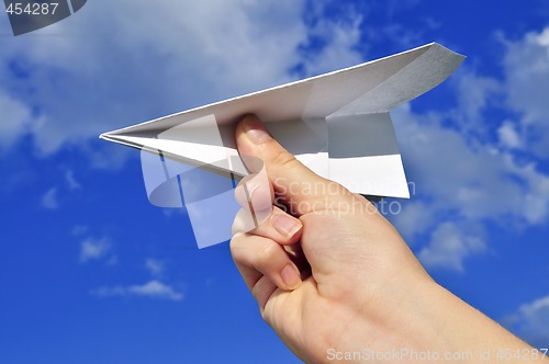 Image of Hand holding paper airplane