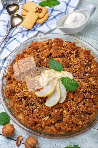 Image of Pear crumble with a sprig of mint.