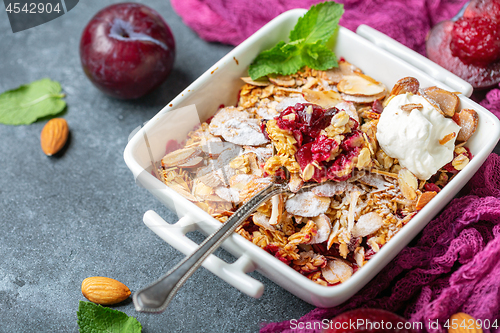 Image of Red plum crumble with crunchy oatmeal and almond.