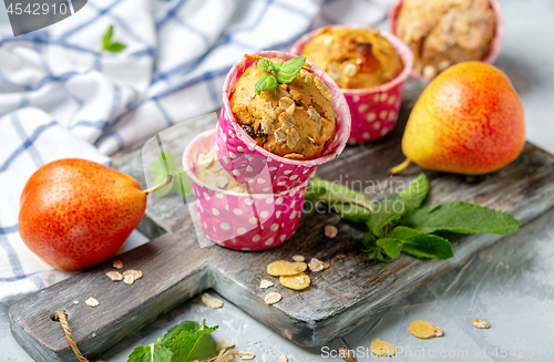 Image of Homemade muffins with pear and granola.