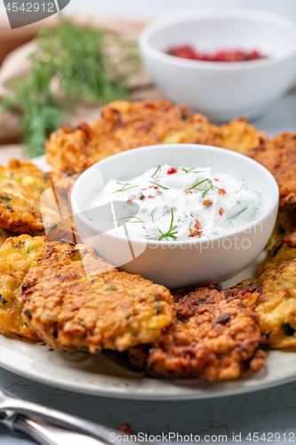 Image of Zucchini fritters with spicy yogurt sauce.