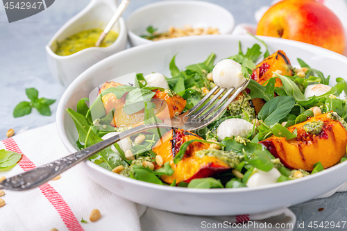 Image of Salad with grilled nectarines, arugula and pesto.