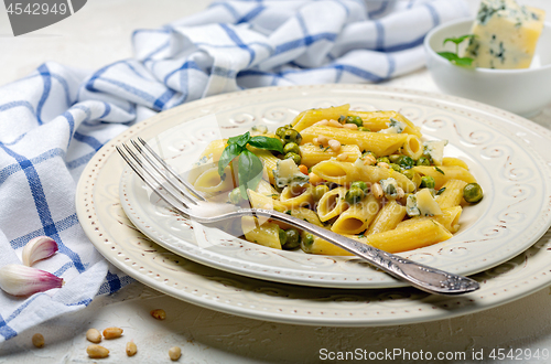 Image of Delicious pasta with green peas and blue cheese.
