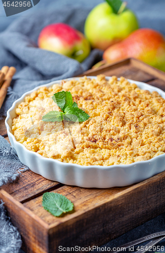 Image of  Apple crumble in white ceramic baking form.