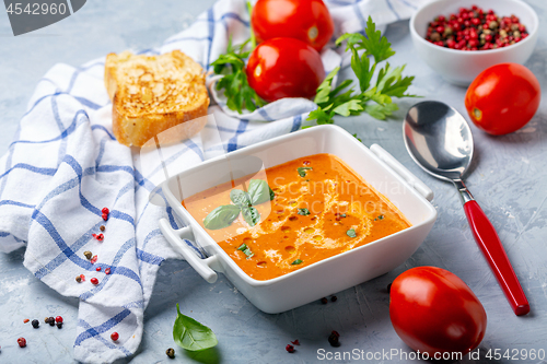 Image of Tomato soup with green basil.