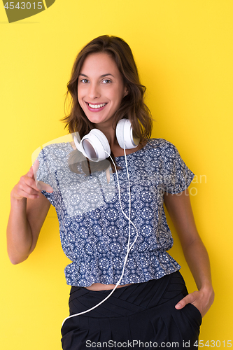 Image of woman with headphones isolated on a yellow