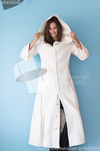 Image of woman in a white coat with hood isolated on blue background