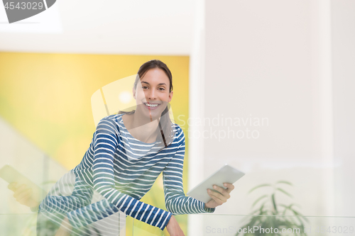 Image of young woman at home websurfing