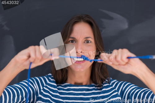 Image of woman holding a internet cable in front of chalk drawing board