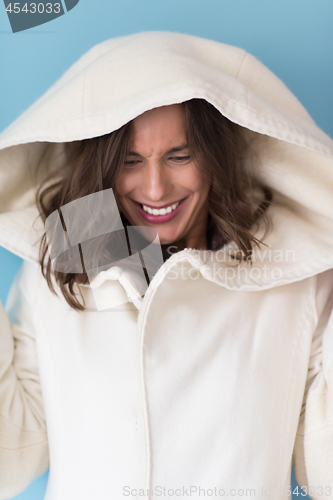 Image of woman in a white coat with hood isolated on blue background