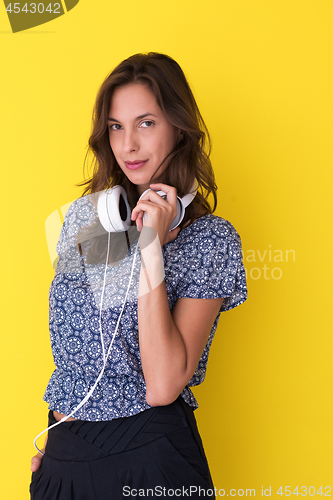 Image of woman with headphones isolated on a yellow