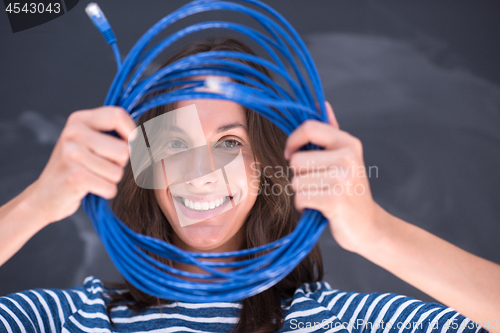 Image of woman holding a internet cable in front of chalk drawing board