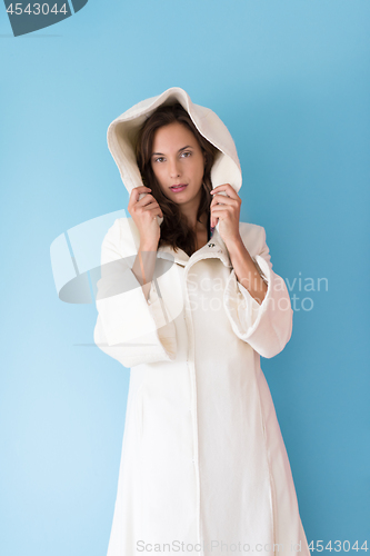 Image of woman in a white coat with hood isolated on blue background