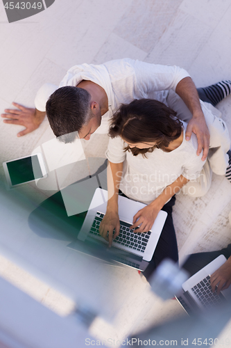 Image of couple using tablet and laptop computers top view