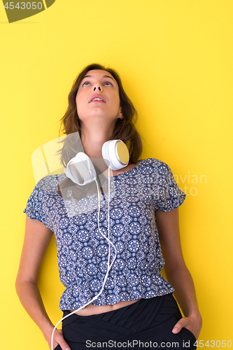 Image of woman with headphones isolated on a yellow