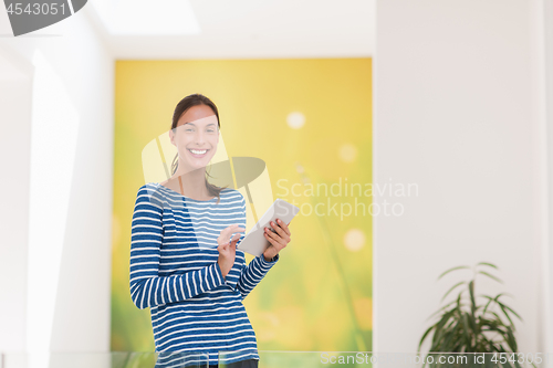 Image of young woman at home websurfing