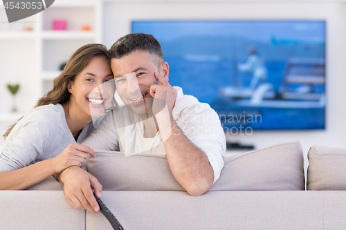 Image of Young couple on the sofa watching television